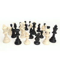 Black and white Staunton chess pieces scattered together.