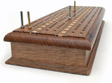 4 metal pegs placed on cribbage board.