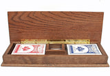Cribbage board opens with compartments for metal pegs and cards.