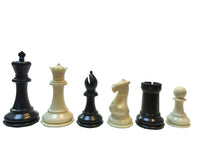 6 black and cream Staunton chess pieces.