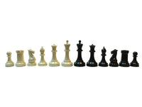12 black and cream Staunton chess pieces.