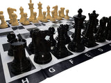 Close up of black chessmen on vinyl chess mat.