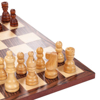 Close up of light brown chessmen in corner of board.