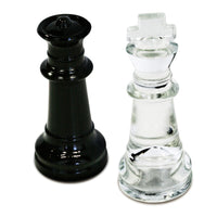 A black and clear chess piece net to each other.