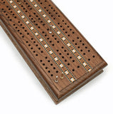 Overhead view of metal pegs in cribbage board.