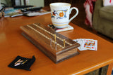 4 easy grip pegs in cribbage board on coffee table.