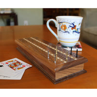 6 metal pegs played on cribbage board on table.