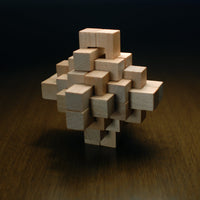Wooden geometric puzzle on wooden table .