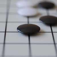 Close up of GO stones on board.