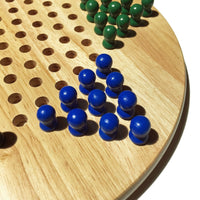 Zoomed in picture of blue wooden pegs inside board.