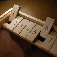 Zoomed in picture of top of shut the box with most the tiles flipped down.
