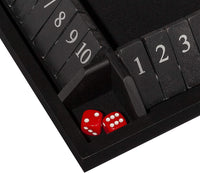 Zoomed in on 2 red dice in the corner of black Shut the Box.