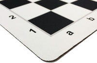 Rounded corner of black mousepad chess mat.