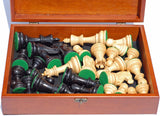 Black stained Kari wood pieces laid down in wooden treasure box.