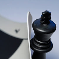 King chess piece lifting the corner of silicone mat.
