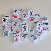 Mahjong pieces piled together on a table.