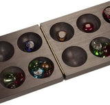 Mancala opened with glass stones in holes.