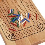 Cribbage board with a bunch of colored pegs piled on top.