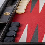Zoomed in or dice holder inside Backgammon and black and white chip lined up.