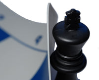 King chess piece lifting up corner of silicone chess board.